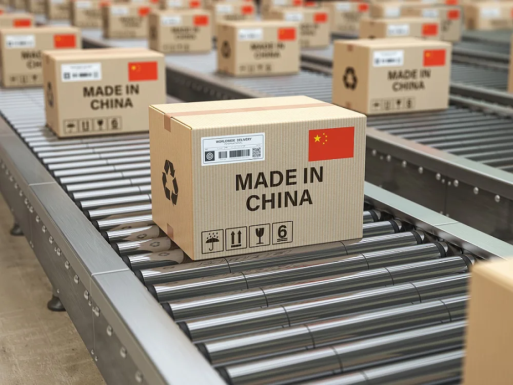 Cardboard Boxes with Made in China Labels on the Conveyor Belt