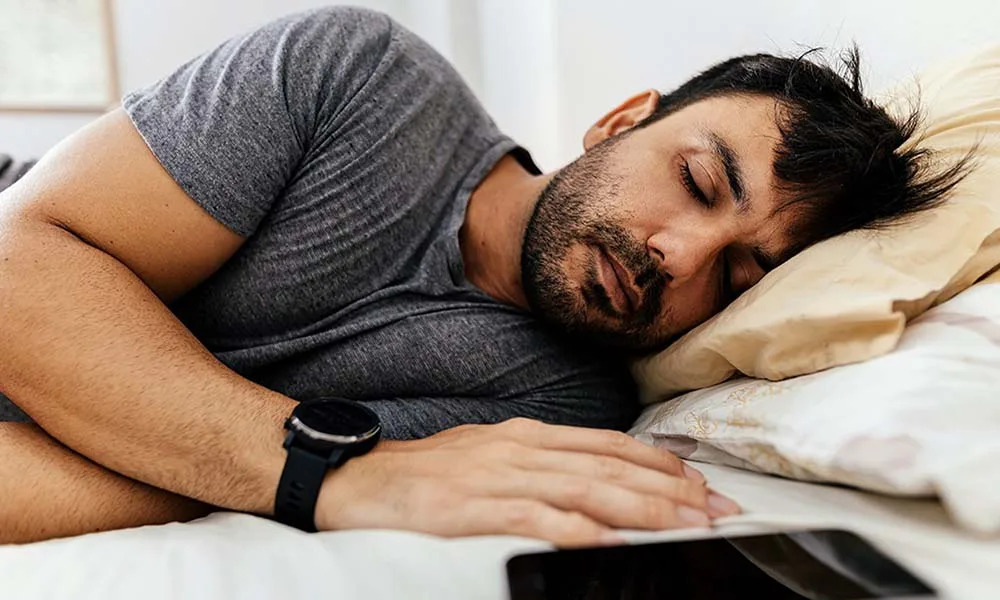 A Man Monitors Sleep Quality Using A Smartwatch